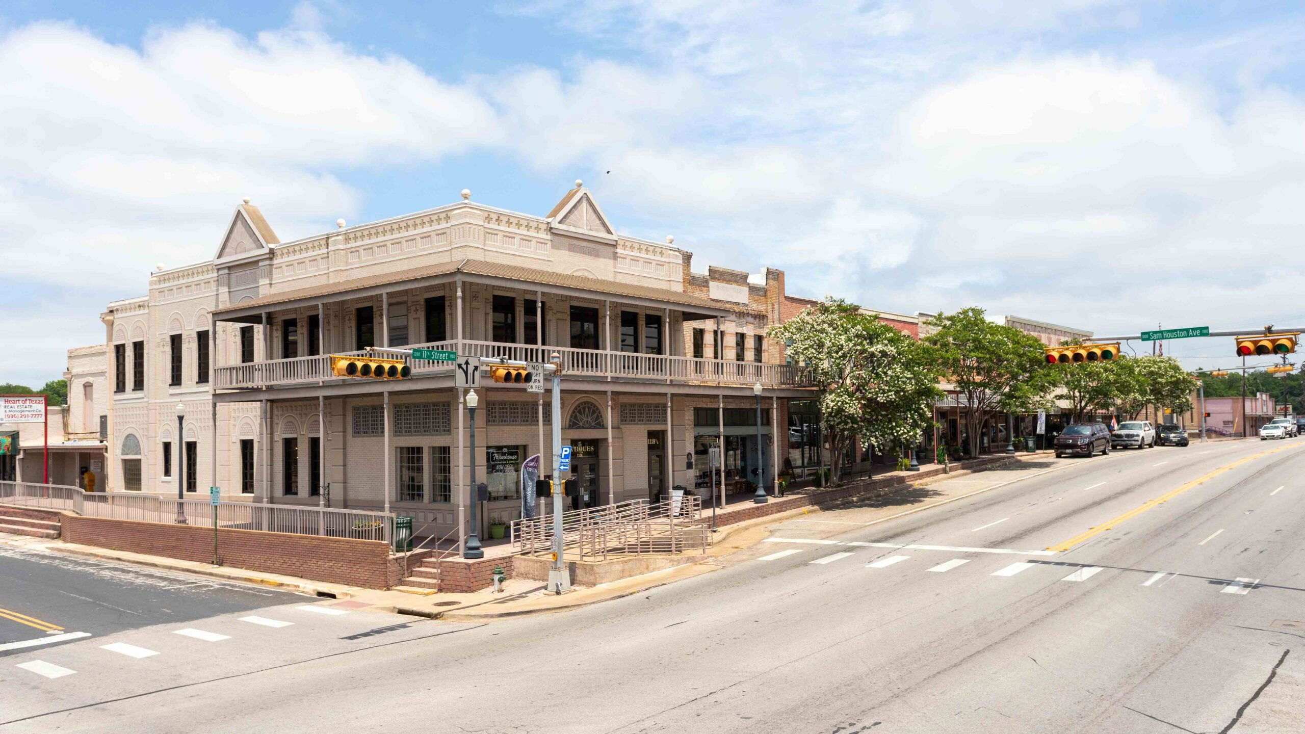 A street intersection with an historic-looking building on the corner.